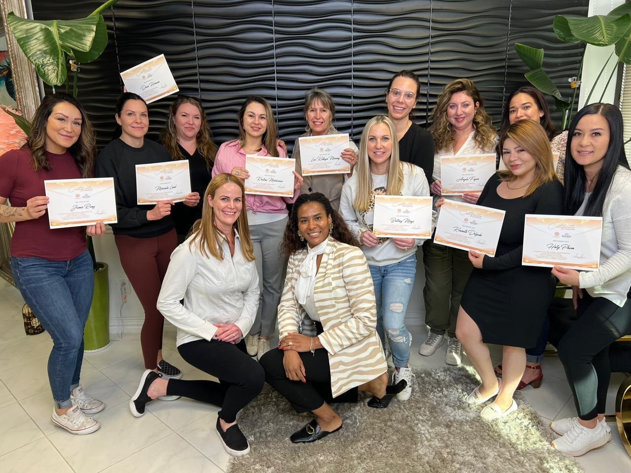 Harlenne with a graduating class, certificates in hand